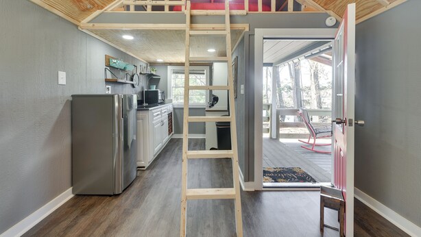 A compact kitchen with a built-in refrigerator, wooden ceiling, and a ladder leading to an upper loft. - Calabash Studio Cabin, 4 Mi to Sunset Beach! (Sunset Beach)