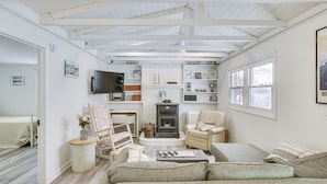 A cozy living room with a fireplace, comfortable seating, and a television. - Riverfront Topsham Home ~ 28 Mi to Portland! (Topsham)