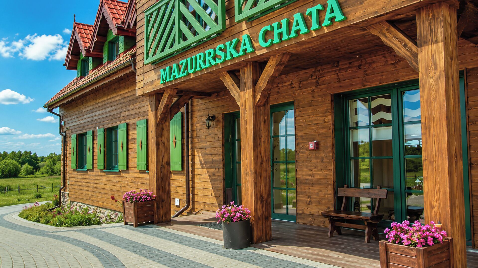 A wooden building with a sign reading 'MAZURSKA CHATA'.