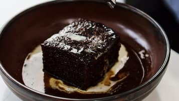 A dessert in a bowl with a spoon.