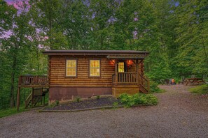 A rustic log cabin with a porch, a fire pit, and outdoor seating. - NEW 2024 Update| Hot Tub | Near Trails| Game Room| Firepit| Secluded 8 acres (Logan)