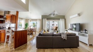 A modern living space with a kitchen, dining area, and a sofa.
