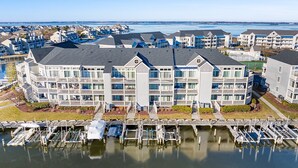A waterfront hotel with multiple balconies, a marina, and a view of the water. - 2 BEDROOM 2 BATH AT ISLAND AT HIDDEN HARBOUR (Ocean City)