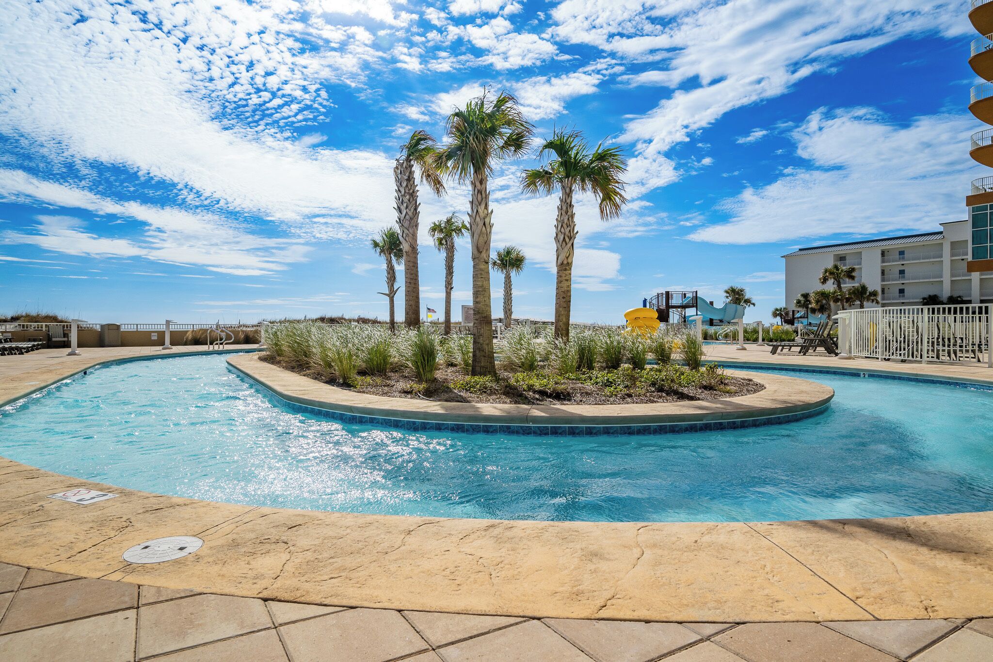 Float around on the lazy river surrounded by palm trees, with fun waterslides and beach access just steps away