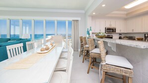 A modern kitchen with white cabinets, a microwave, and a breakfast bar. - Gorgeous Beach Retreat at Phoenix Gulf Towers (Orange Beach)
