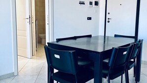 A modern dining area with a rectangular table and six chairs.