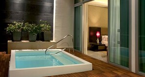 Relax by the pool or unwind in the adjacent room, featuring a comfortable bed and natural views.