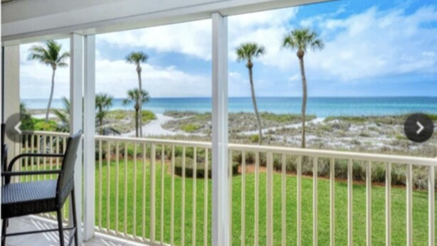 A balcony with a view of a beach and ocean. - Longboat Key Condo with a View (Longboat Key)