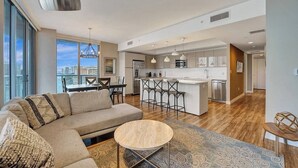 A modern apartment with a living room, kitchen, and dining area. - Luxury Waterfront Condo (Hallandale Beach)