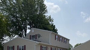 A two-story house with a garage, a satellite dish, and a well-maintained lawn. - 3 bedroom/2 bath home; close to EAA. Large kitchen and outside deck area  (Oshkosh)