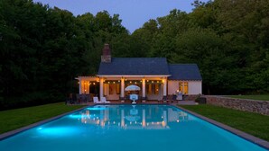 A house with a swimming pool, outdoor seating, and string lights. - Stone Cottage at Roundtop Estate couples Retreat (Wrightsville)