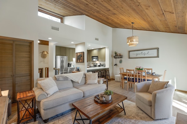 Relaxing family room with high ceiling, open to the renovated kitchen.