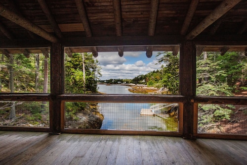 Renovated 3-BR boathouse built atop water in quiet cove; private float & trails