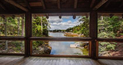Renovated 3-BR boathouse built atop water in quiet cove; private float & trails