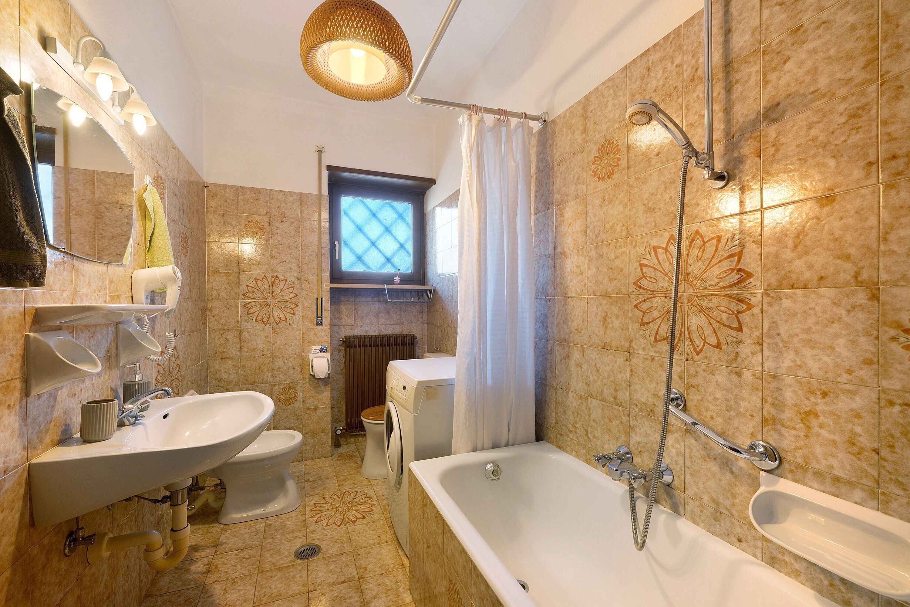 A bathroom with a sink, toilet, bathtub, and shower.