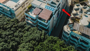 An aerial view of a densely packed urban area with multi-story buildings, some with flat roofs and others with sloped roofs. - ParkApart Rhodes Town (Rhodes)