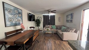 A living room with a wooden dining table, a sofa, a coffee table, and a ceiling fan. - 5 minutes walk to the town square. Gated Community condo w (Crucecita)