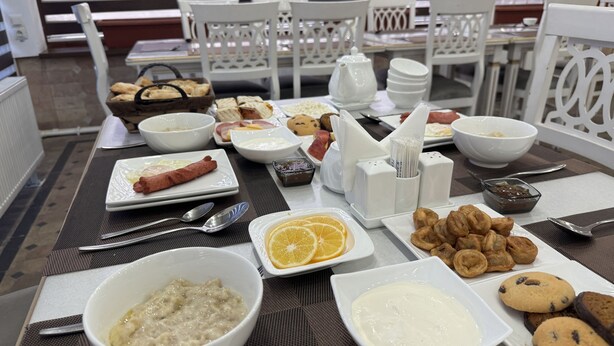 A breakfast buffet with various dishes, including hot dogs, pastries, and fruit. - Rayyan Hotel EXPRESS (Salor)