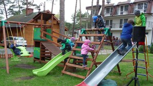 A playground with a slide, climbing structures, and swings. - Four -anniversary Type B (Dzwirzyno)