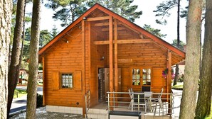 A wooden cabin with a porch, a door, and a sign that reads 'MALGOSA'. - Four -anniversary Type B (Dzwirzyno)