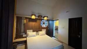 A bedroom with a bed, a ceiling fan, a large window, and a door.
