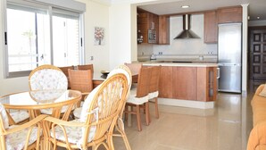 A modern kitchen with wooden cabinets, stainless steel appliances, and a central island. - MAR Y VENT - SEA VIEW (3 BEDROOMS) (Benidorm)