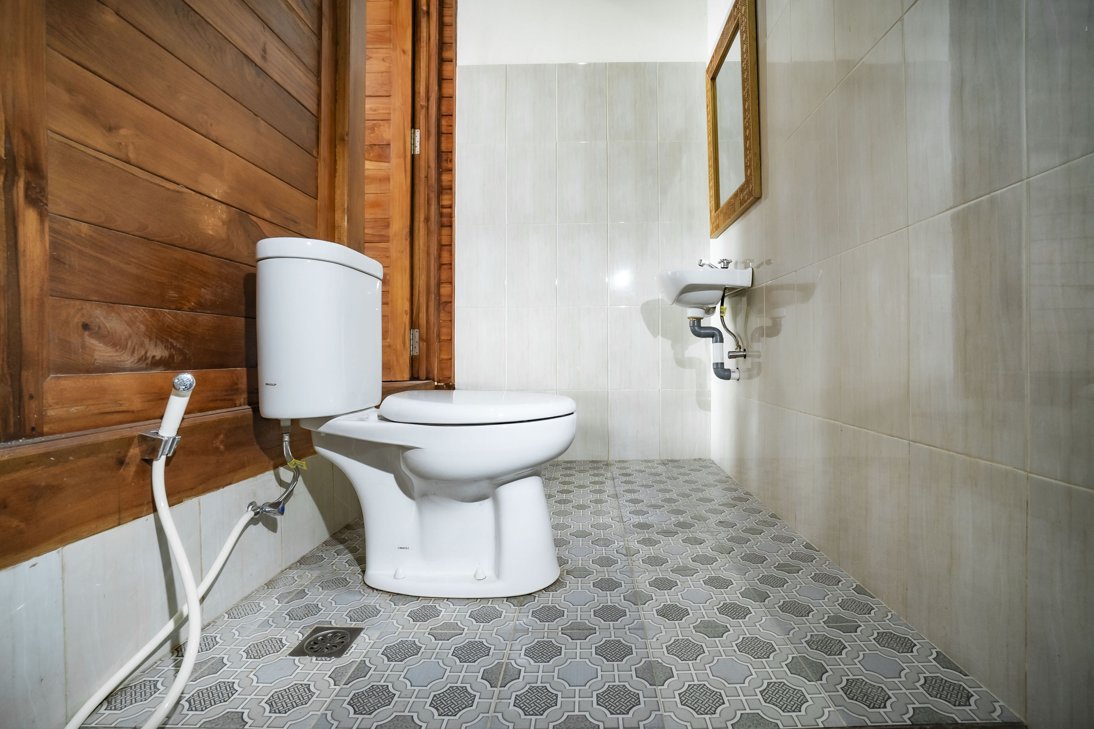 A bathroom with a toilet, a sink, and a shower.