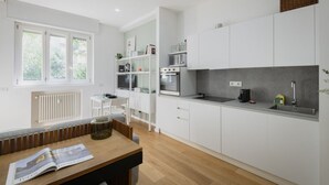 A modern kitchen with white cabinetry, a built-in oven, and a countertop with a sink. - Easylife - Elegance and Comfort in the Isola area (Milano)