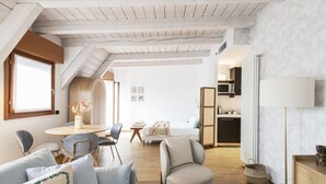 A modern, open-plan living space with a loft bedroom, a dining area, and a kitchen. - Easylife - Exclusive penthouse with panoramic view (Milano)