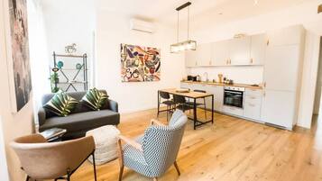 A modern apartment with a living area, dining space, and kitchen.