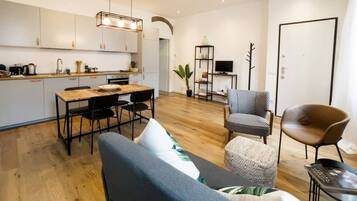 A modern apartment with a kitchen, dining area, and living space.
