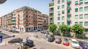 A multi-story residential building with balconies, a parking area, and a pedestrian crossing. - Easylife - Spacious and new apt in Città Studi (Milano)
