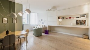 A modern living space with a dining area, a sofa, and a bookshelf. - Easylife - Precious Pearl in Porta Romana (Milano)