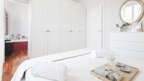 A bedroom with a bed, a dresser, a mirror, and a window. - Easylife - Oasis of comfort&style in Porta Romana (Milano)