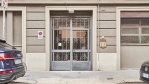 A building with a double garage door, a no parking sign, and a mailbox.
