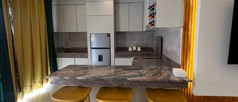 Fridge, stovetop, electric kettle, cookware/dishes/utensils