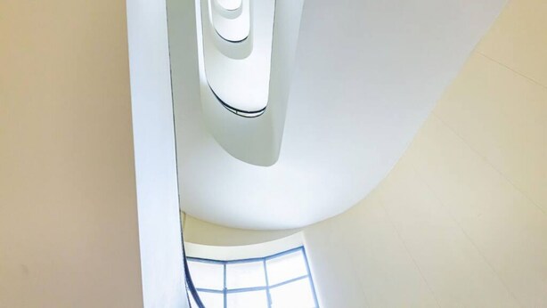 A high ceiling with a large, curved architectural feature.