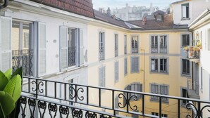 A row of buildings with balconies and shutters, featuring a mix of architectural styles and colors.