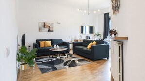 A modern living room with two sofas, a coffee table, and a floor lamp.