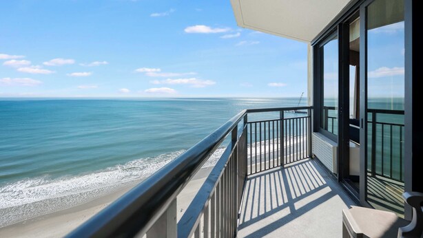 A balcony with a view of the ocean and beach. - New Coastal Charm, Direct Oceanfront Views, Pools! (Myrtle Beach)