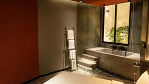A modern bathroom with a stone sink, a glass shower enclosure, and a towel rack. - Kin Wander Tan Binh, The Mountain (Ho Chi Minh City)