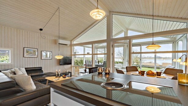 A modern kitchen with a large island, large windows, and a view of the outdoors. - 2 bedroom nice home in Kerteminde (Kerteminde)