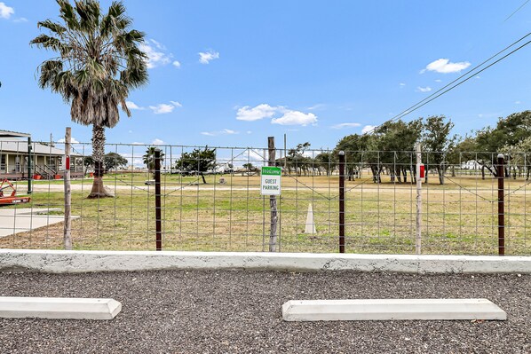 A fenced area with a sign indicating guest parking.