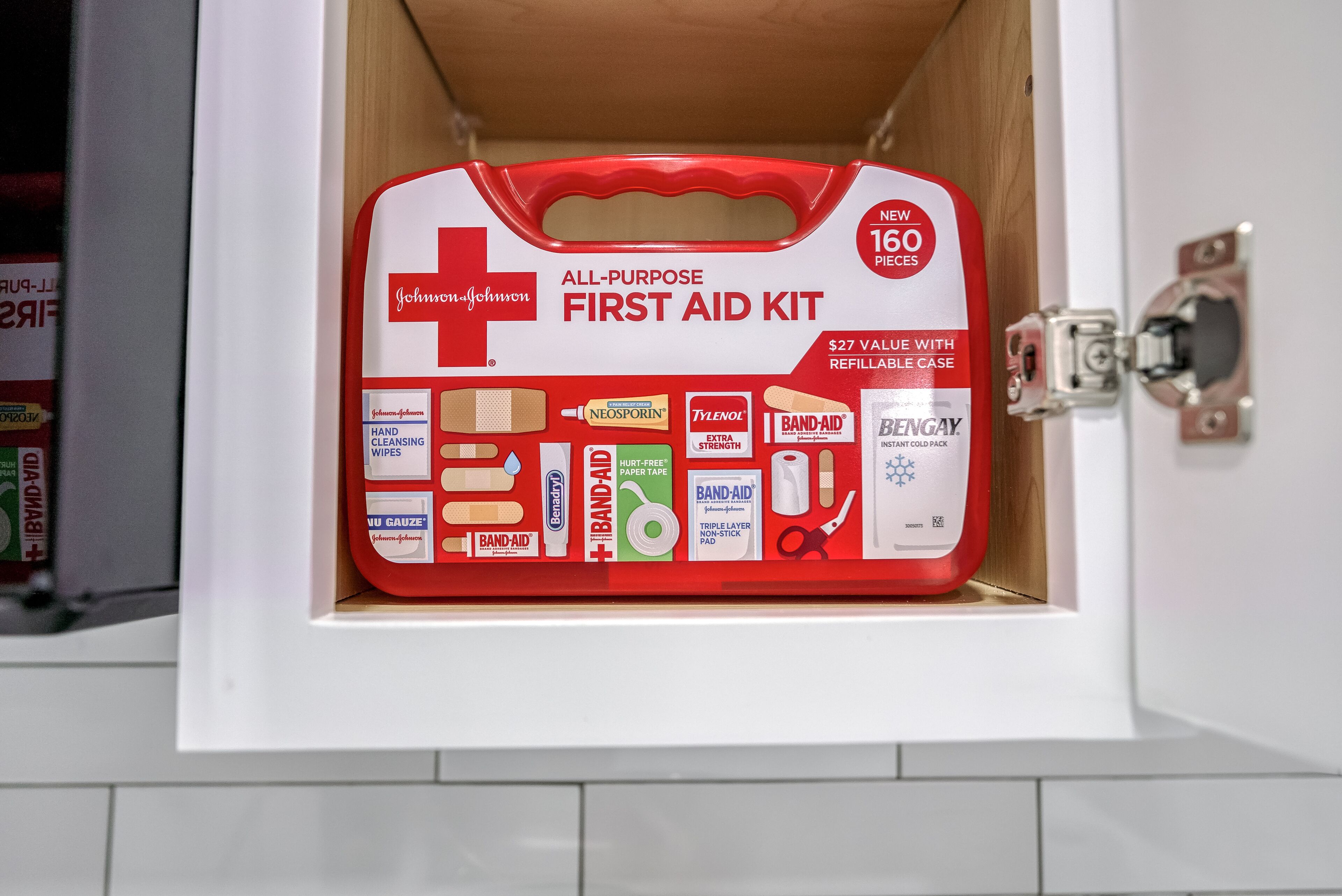 A first aid kit in a cabinet.