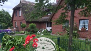 A sign for Reethaus Biosphärenreservat with contact information and a website URL.