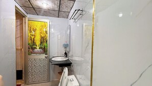 A bathroom with a toilet, sink, and shower. - Gia Bao Hotel Binh Thanh - by BayLuxury (Ho Chi Minh City)