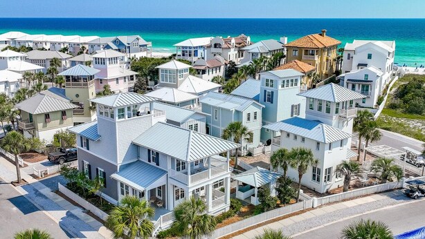 A coastal residential area with houses featuring balconies and a view of the ocean. - Seas The Moments: Next to beach walkover, across the street from the pool! (Panama City Beach)