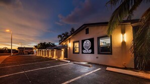 A building with a sign reading 'Las Olas Treasure Island' and a parking lot.