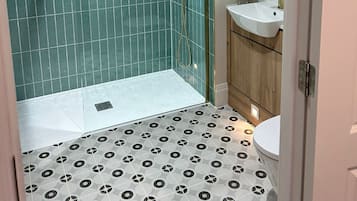 Shower, designer toiletries, hair dryer, bathrobes