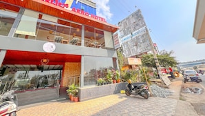 A building with a sign for 'Aero Hotel' and a balcony with chairs and tables. - Aero Hotel Near Bangalore International Airport (Bengaluru)